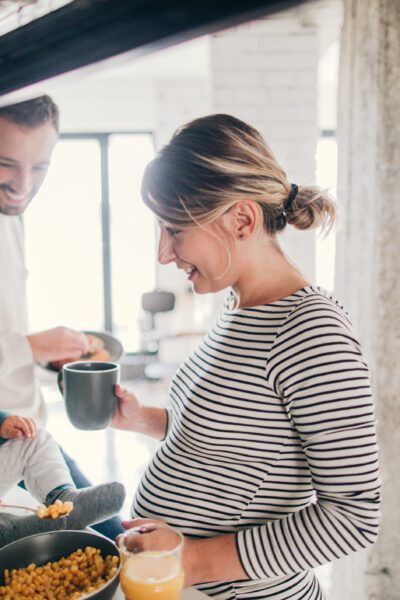 Photo of a young family preparing breakfast together in their kitchen